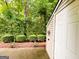 Backyard featuring a storage shed and manicured garden hedging at 3150 Stratford Green Pl, Avondale Estates, GA 30002