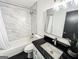 Elegant bathroom featuring a marble-tiled shower, modern vanity with black countertop, and sleek fixtures at 3150 Stratford Green Pl, Avondale Estates, GA 30002