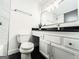 Nicely designed bathroom with black tile floors, a white vanity, and a toilet at 3150 Stratford Green Pl, Avondale Estates, GA 30002