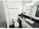 Bathroom features white vanity with black countertop, toilet, and marble tiled shower walls at 3150 Stratford Green Pl, Avondale Estates, GA 30002