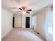 Bright and airy bedroom featuring a ceiling fan, neutral carpet, and ample natural light at 3150 Stratford Green Pl, Avondale Estates, GA 30002