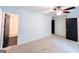 Spacious bedroom with ceiling fan, neutral carpet, and modern doorways leading to other rooms at 3150 Stratford Green Pl, Avondale Estates, GA 30002