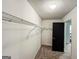 A walk-in closet with carpet flooring, metal shelving, and a dark doorframe at 3150 Stratford Green Pl, Avondale Estates, GA 30002