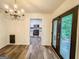 Charming dining room area with wood flooring, chandelier, and an open view into the kitchen at 3150 Stratford Green Pl, Avondale Estates, GA 30002