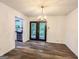 Elegant dining room with a chandelier, wood floors, and access to the backyard patio at 3150 Stratford Green Pl, Avondale Estates, GA 30002