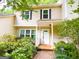 Inviting two-story townhome with a classic white front door and well-maintained landscaping at 3150 Stratford Green Pl, Avondale Estates, GA 30002