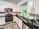 Updated kitchen featuring granite countertops, stainless steel appliances, and white cabinetry at 3150 Stratford Green Pl, Avondale Estates, GA 30002