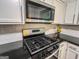 Updated kitchen features stainless steel appliances, black countertops, and white cabinets at 3150 Stratford Green Pl, Avondale Estates, GA 30002