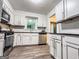 Updated kitchen featuring stainless appliances, wood floors and white cabinetry at 3150 Stratford Green Pl, Avondale Estates, GA 30002