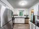 Bright kitchen with stainless steel appliances and view to the backyard at 3150 Stratford Green Pl, Avondale Estates, GA 30002