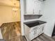Bright kitchenette with white cabinets, black counters and a view into the dining room at 3150 Stratford Green Pl, Avondale Estates, GA 30002