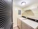 Functional laundry room with washer, dryer, and storage shelving at 3150 Stratford Green Pl, Avondale Estates, GA 30002