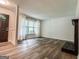 A spacious living room featuring wood-look floors, a fireplace, and large windows for natural light at 3150 Stratford Green Pl, Avondale Estates, GA 30002