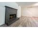 Spacious living room with a black brick fireplace and modern flooring at 3150 Stratford Green Pl, Avondale Estates, GA 30002