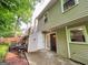 The patio is surrounded by lush trees, shrubs, and a small garden adding to the home's curb appeal at 3150 Stratford Green Pl, Avondale Estates, GA 30002