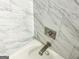 Close-up of a shower featuring sleek fixtures and faux marble tiles at 3150 Stratford Green Pl, Avondale Estates, GA 30002