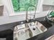 Stainless steel double sink with black countertop and window view at 3150 Stratford Green Pl, Avondale Estates, GA 30002