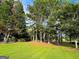 Expansive backyard with mature trees and lush green grass for outdoor activities at 3150 Stratford Green Pl, Avondale Estates, GA 30002