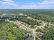 Serene aerial view of a neighborhood surrounded by lush forest, showcasing a community nestled in nature at 185 Discovery Lake Dr, Fayetteville, GA 30215