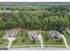 Aerial shot of suburban homes each with expansive lawns and mature trees on a sunny day at 185 Discovery Lake Dr, Fayetteville, GA 30215