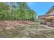 Spacious backyard featuring a rock drain and inviting patio with comfortable seating, ideal for relaxation and outdoor gatherings at 185 Discovery Lake Dr, Fayetteville, GA 30215