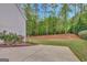 Beautiful backyard featuring mature trees and a concrete patio at 185 Discovery Lake Dr, Fayetteville, GA 30215