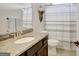 Clean bathroom featuring a granite countertop vanity and a shower with a stylish striped curtain at 185 Discovery Lake Dr, Fayetteville, GA 30215