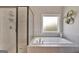 Bathroom featuring a soaking tub and a separate glass-enclosed shower with modern fixtures at 185 Discovery Lake Dr, Fayetteville, GA 30215