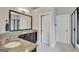 Bathroom featuring granite counters, dual vanities, and a framed mirror at 185 Discovery Lake Dr, Fayetteville, GA 30215