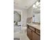 Modern bathroom showcasing a vanity with a granite countertop, ample lighting, and a view of a sitting area at 185 Discovery Lake Dr, Fayetteville, GA 30215