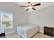 Comfortable bedroom with a ceiling fan, natural light, and a neutral color palette at 185 Discovery Lake Dr, Fayetteville, GA 30215