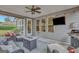 Inviting covered patio featuring a ceiling fan, outdoor furniture, grill, and television for comfortable outdoor living at 185 Discovery Lake Dr, Fayetteville, GA 30215