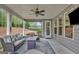 Relaxing covered patio with comfortable seating, a ceiling fan, and a view of the landscaped backyard at 185 Discovery Lake Dr, Fayetteville, GA 30215