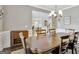 Traditional dining room with hardwood floors, chandelier and wainscoting, seamlessly blending into the living space at 185 Discovery Lake Dr, Fayetteville, GA 30215