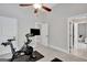 Bright exercise room with a ceiling fan, workout equipment, and view to sitting room and a hallway at 185 Discovery Lake Dr, Fayetteville, GA 30215