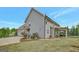 Beautiful home exterior with well-maintained lawn and landscaping and a covered patio with outdoor furniture at 185 Discovery Lake Dr, Fayetteville, GA 30215