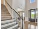 Bright foyer boasting hardwood floors, carpeted staircase, and a view into the formal dining room at 185 Discovery Lake Dr, Fayetteville, GA 30215