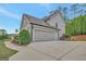 Spacious three-car garage featuring an extra-wide driveway at 185 Discovery Lake Dr, Fayetteville, GA 30215