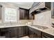Functional kitchen showcasing light countertops, dark cabinetry, a stainless steel sink, and a gas stovetop at 185 Discovery Lake Dr, Fayetteville, GA 30215