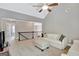 Open living room with two sofas and a ceiling fan and access to the stairway and another room at 185 Discovery Lake Dr, Fayetteville, GA 30215