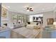 Inviting living room with modern furniture, fireplace, natural light, and open view to the kitchen at 185 Discovery Lake Dr, Fayetteville, GA 30215