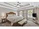 Luxurious primary bedroom with trey ceilings, a ceiling fan, and bench at the foot of the bed at 185 Discovery Lake Dr, Fayetteville, GA 30215