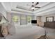 Comfortable main bedroom with large bed, trey ceilings, ceiling fan, and natural light at 185 Discovery Lake Dr, Fayetteville, GA 30215