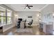 Bright home office with large window, two desks, hardwood floors, ceiling fan, and recessed lighting at 185 Discovery Lake Dr, Fayetteville, GA 30215