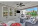 Spacious covered patio with comfortable wicker seating, a ceiling fan, a television, and an outdoor dining area at 185 Discovery Lake Dr, Fayetteville, GA 30215