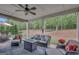 Covered patio with comfortable outdoor seating, a ceiling fan, decorative lights, and a view of the backyard at 185 Discovery Lake Dr, Fayetteville, GA 30215