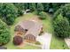Aerial view of brick home with manicured lawn, mature trees, and long driveway at 280 Ridgemont Dr, Fayetteville, GA 30215