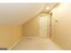 Finished attic space with carpeted flooring, an access door, and white trim at 280 Ridgemont Dr, Fayetteville, GA 30215