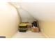 Attic space featuring angled ceilings, storage containers, and a Home Depot moving box at 280 Ridgemont Dr, Fayetteville, GA 30215