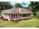 Wide shot of backyard featuring a spacious yard and screened-in porch at 280 Ridgemont Dr, Fayetteville, GA 30215